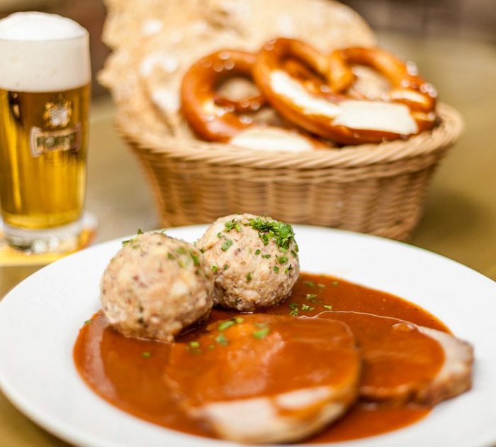 Bavarian meal with dumplings, roast pork, pretzels, and beer
