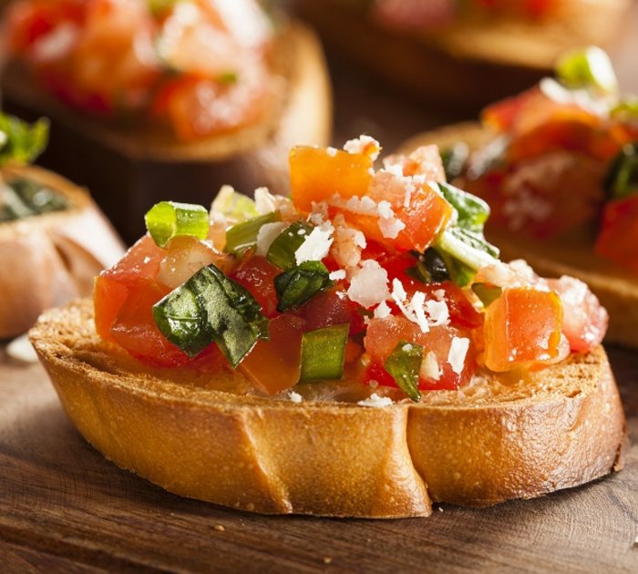Bruschetta with chopped tomatoes, basil, and parmesan on bread